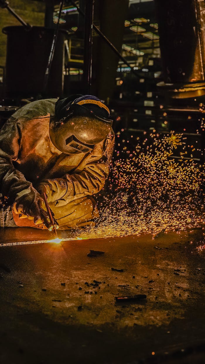 Crafting Captivating Headlines: Your awesome post title goes here A welder in protective gear works with sparks flying in an industrial setting.